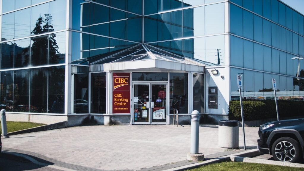 a car is parked in front of a glass building