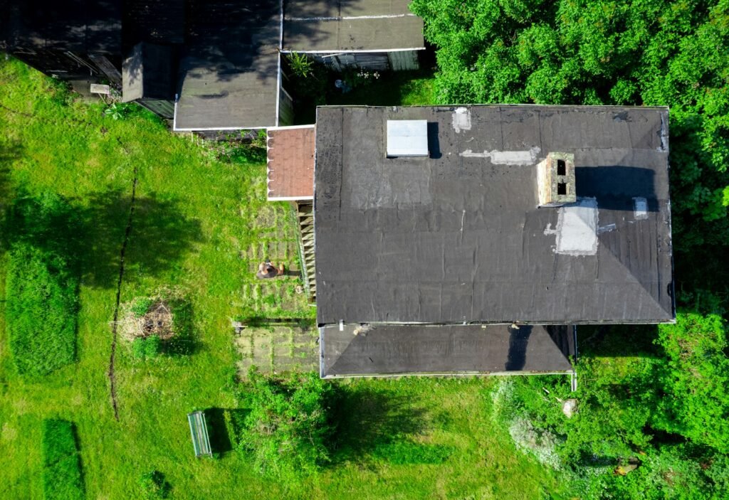 an aerial view of a house surrounded by trees